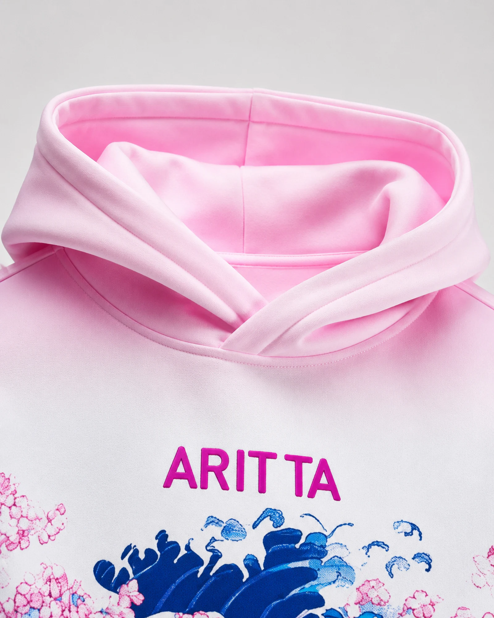 Detail of the pink hood, ARITTA mark and wave print